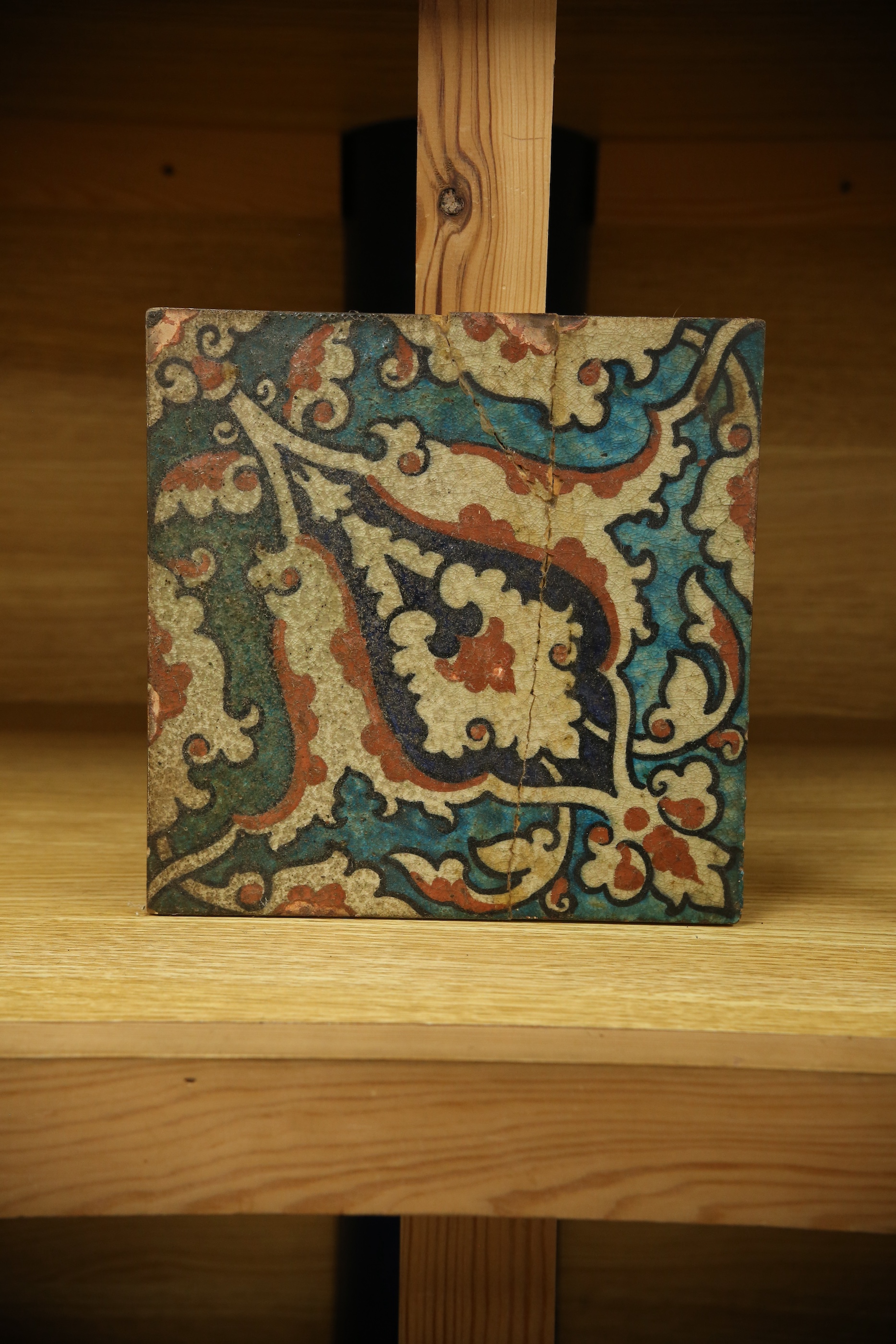 A 17th century style Iznik pottery tile, 20.5cm sq. Condition - poor